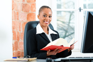 Young female lawyer working in her office with a typical law boo