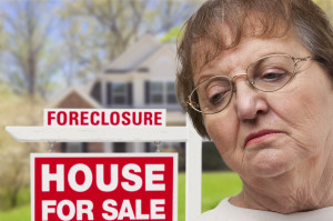 Depressed Senior Woman in Front of Foreclosure Real Estate Sign